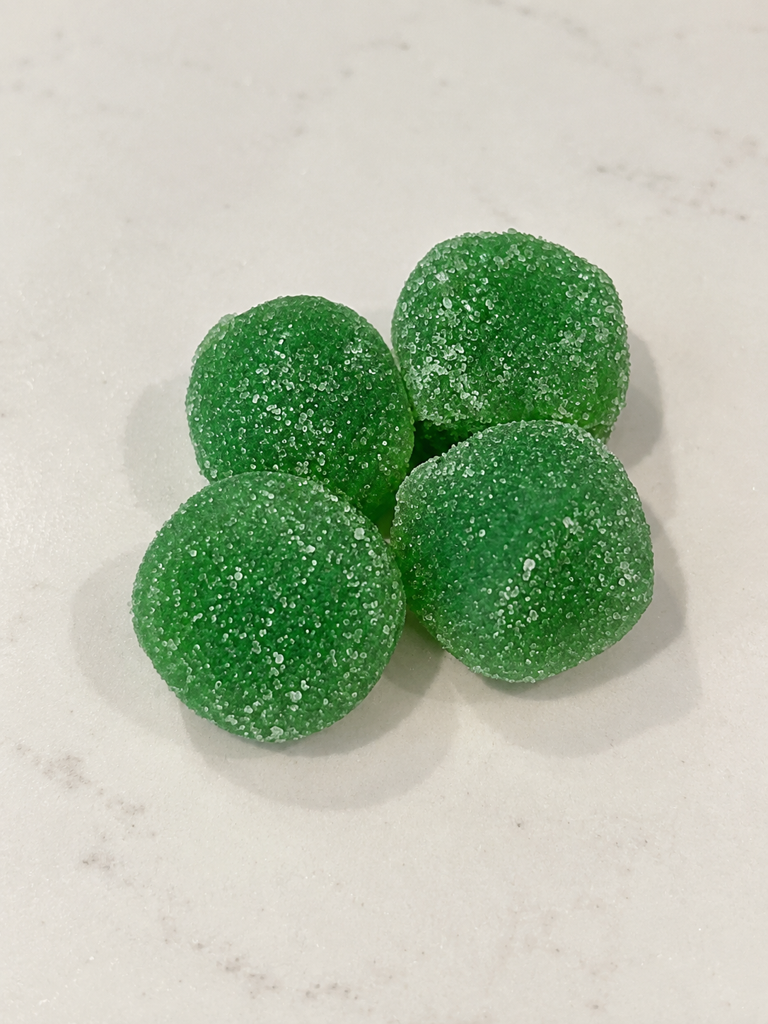 NuKosh green creatine gummies on a clean surface